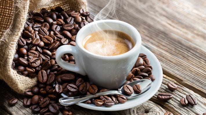 Espresso Coffee Cup With Beans On Vintage Table